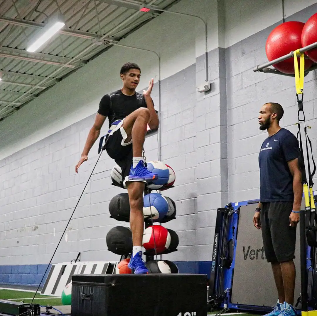 Athlete doing box jump training in gym
