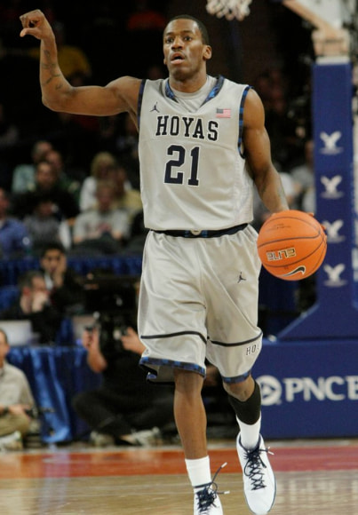 Basketball player dribbling on court.