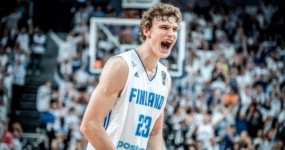 Basketball player cheering energetically on the court.