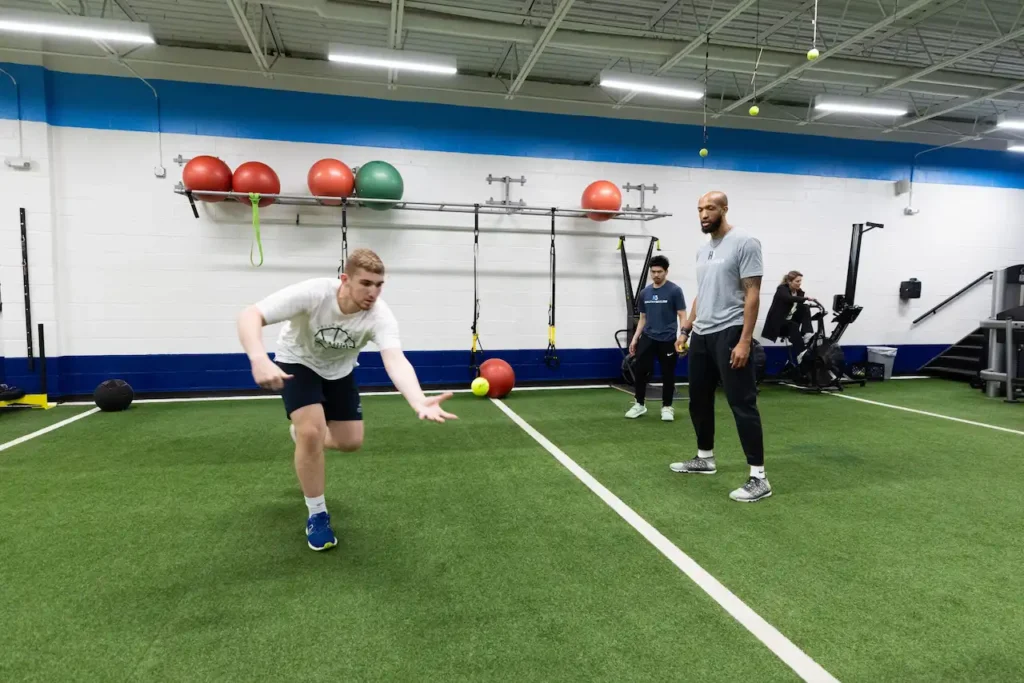 People training in a gym with exercise equipment.