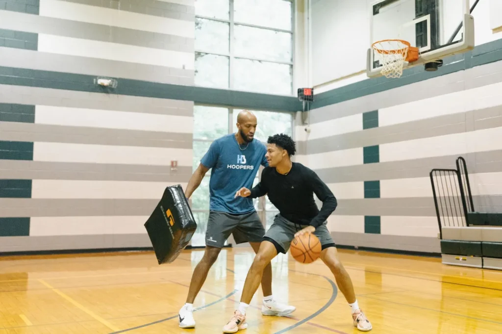 Basketball training session in indoor gym.