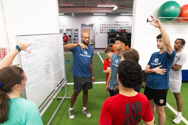 Coach explaining strategy to basketball team.