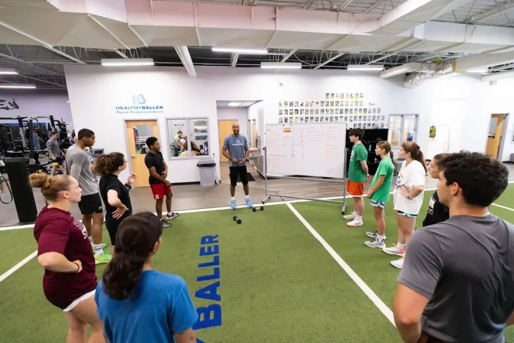 Group fitness training session with coach and athletes.