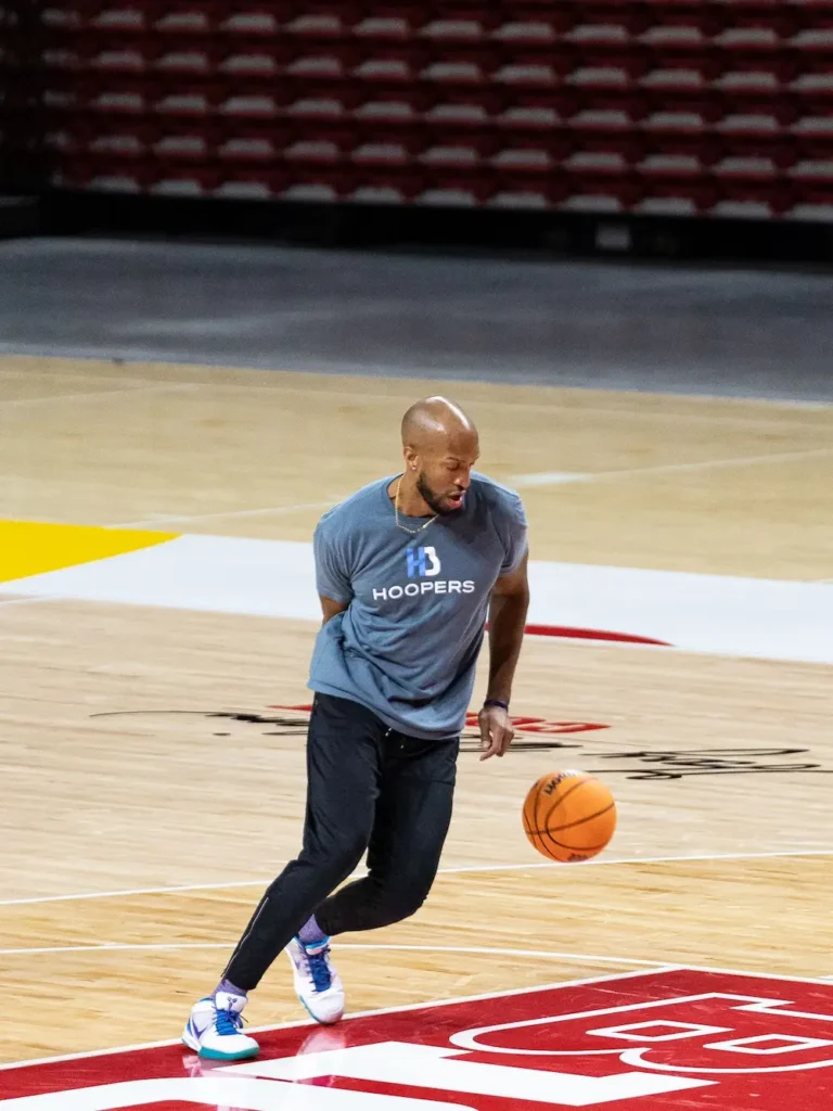 Man dribbling basketball on indoor court
