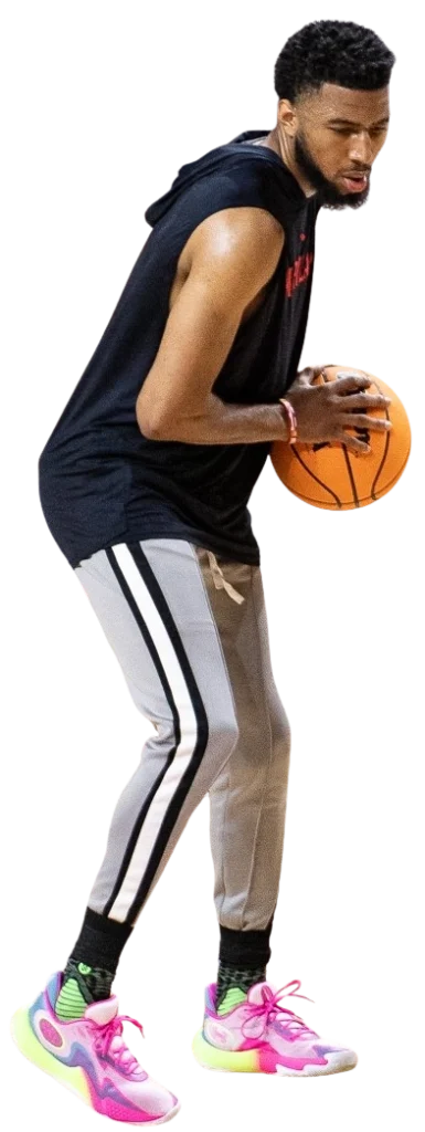 Basketball player in action with ball.
