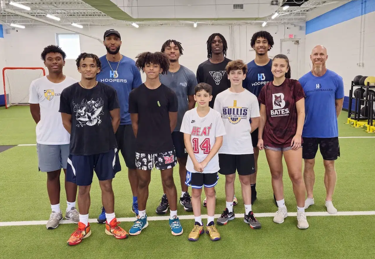 Group photo on indoor turf field.