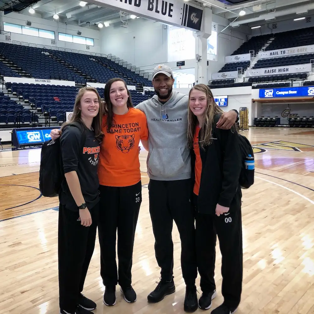Group of athletes on basketball court indoors.