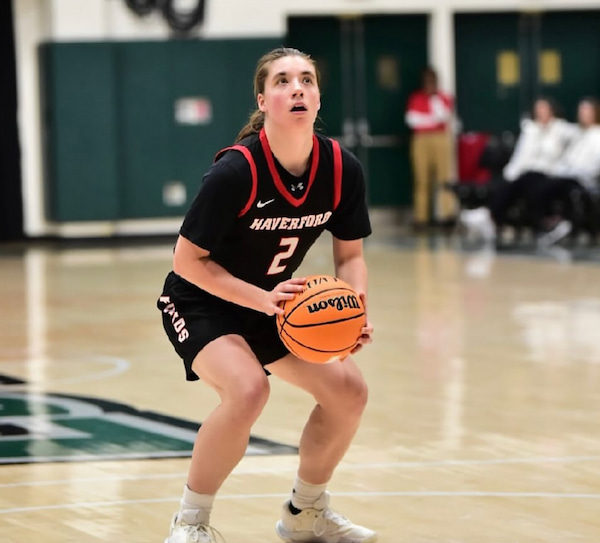 Basketball player aiming for a shot during game.