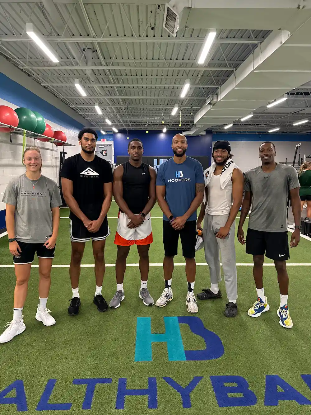 Group of athletes in indoor training facility.