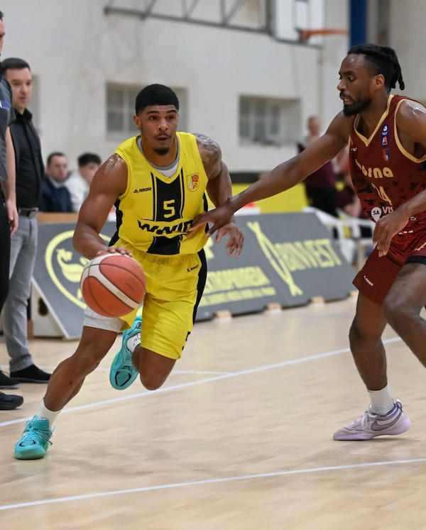 Basketball players in action during a game.